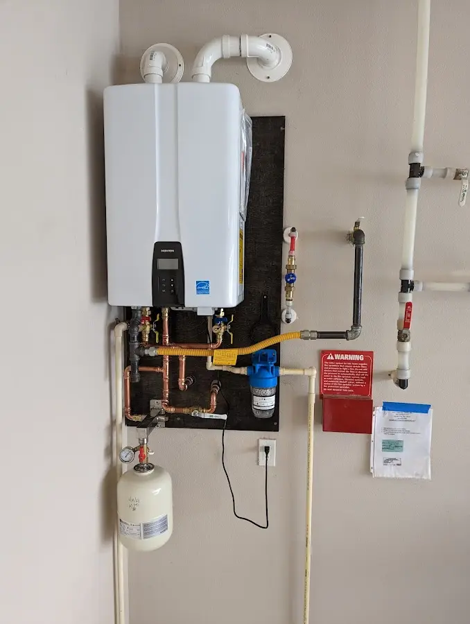 Professional plumber installing copper piping in a Fort Gratiot home